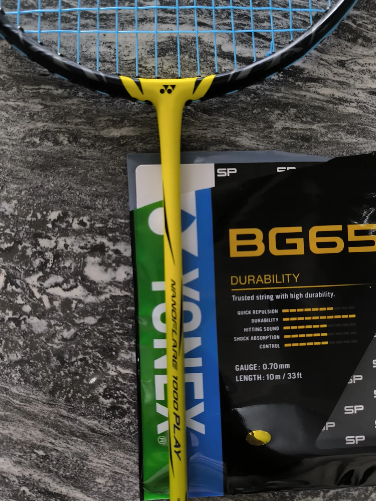 Close-up of customised string bed and tension information on Yonex Nanoflare 1000 Play